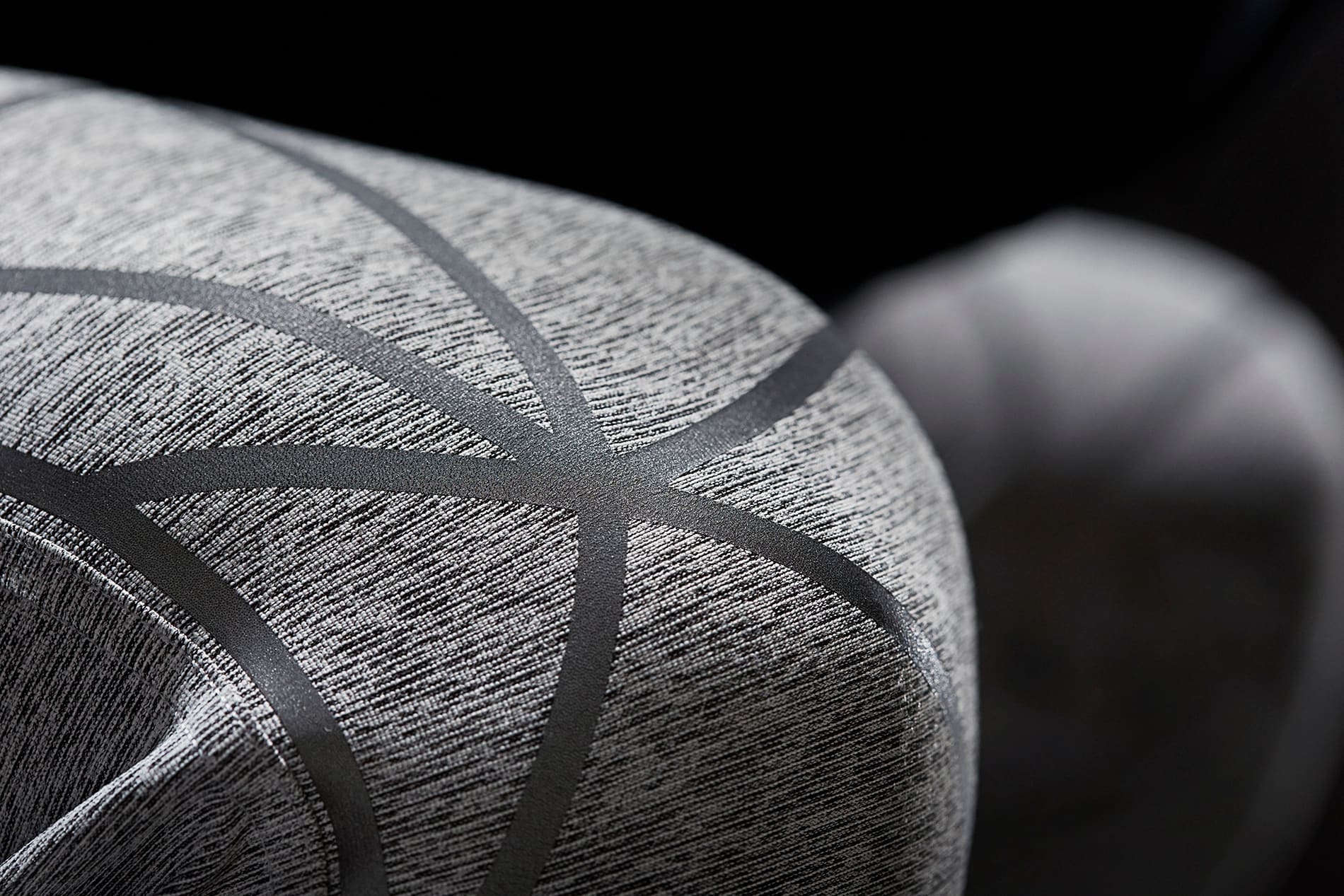 Close-up of 3M Scotchlite Black Stretch Reflective stretching over knees of activewear pants.
