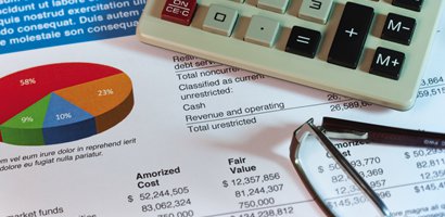 Calculator and eyeglasses on data sheet

